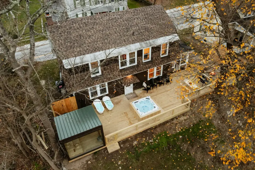 Aerial view of a house with a back deck and hot tub